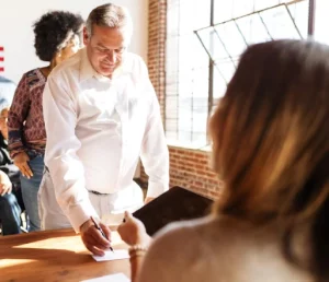 business-meeting-with-document-signing-recertion-desk-us-election-station-us-election-day-us-election-day-people-vote-american-democracy_53876-1089786 - VA Loans Florida